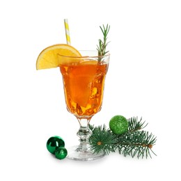 Photo of Tasty Christmas cocktail in glass, baubles and fir tree branches isolated on white