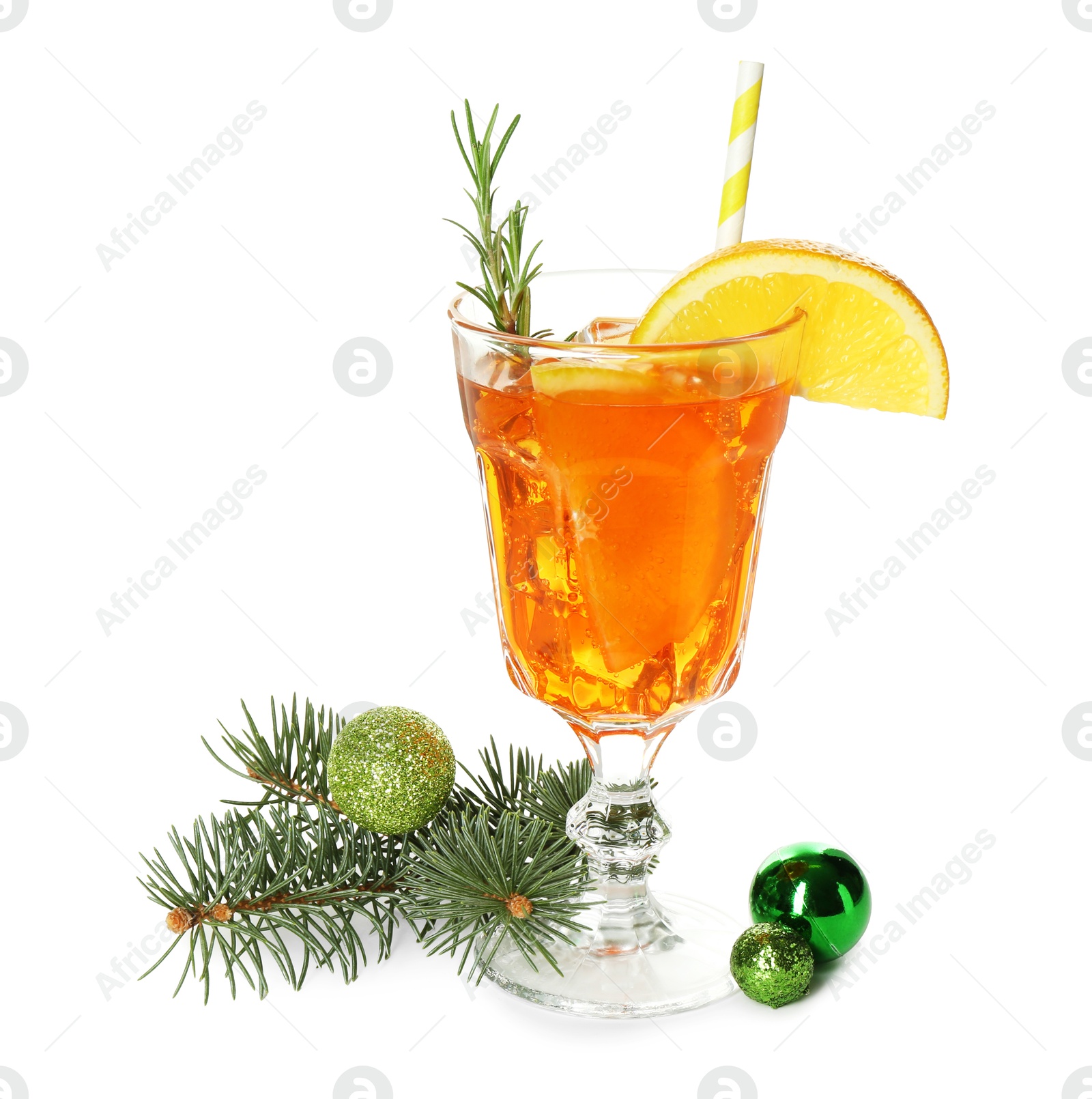 Photo of Tasty Christmas cocktail in glass, baubles and fir tree branches isolated on white