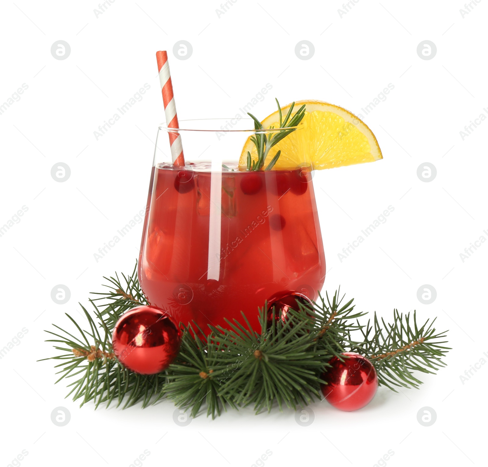 Photo of Tasty Christmas cocktail in glass, baubles and fir tree branches isolated on white