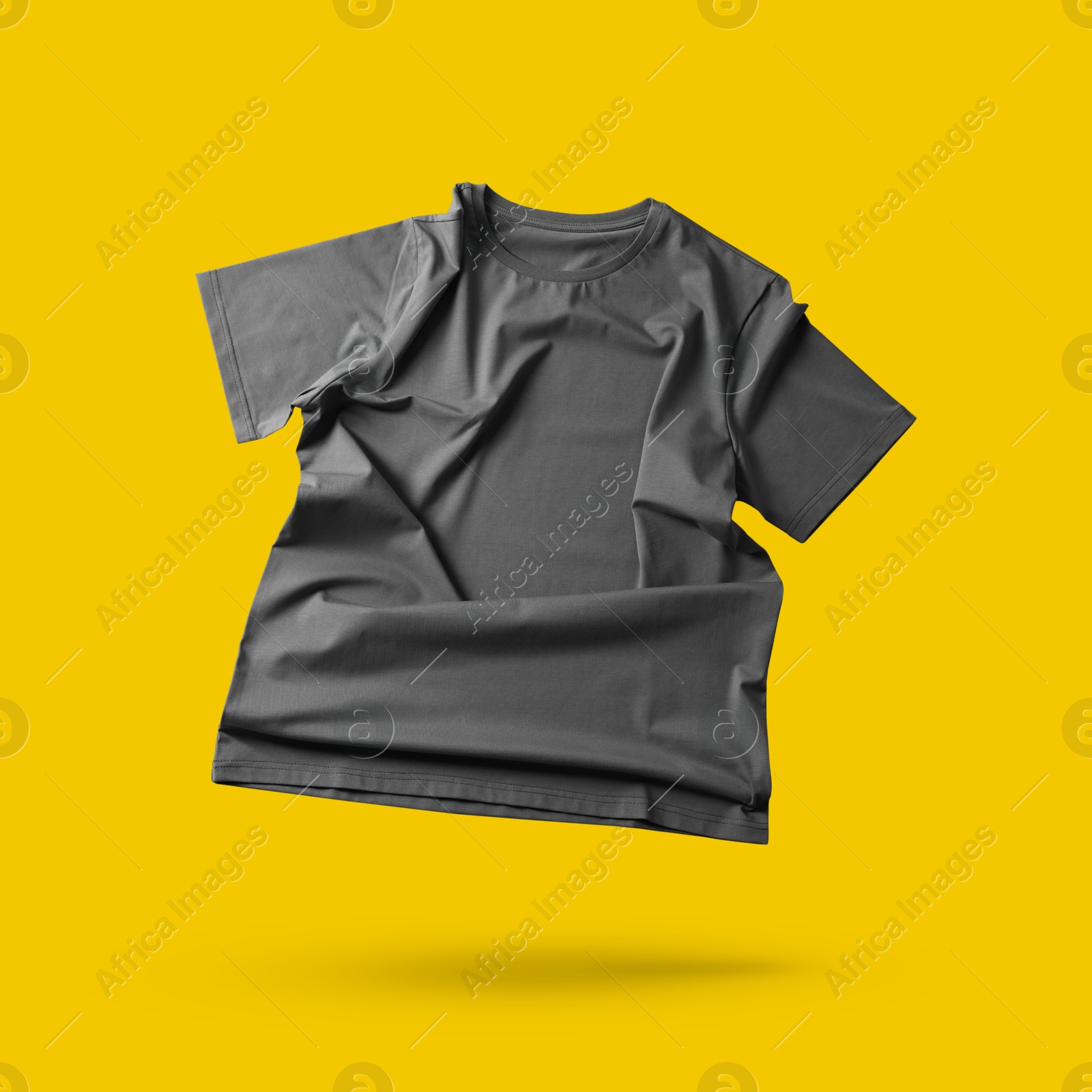 Image of Grey t-shirt in air on golden background