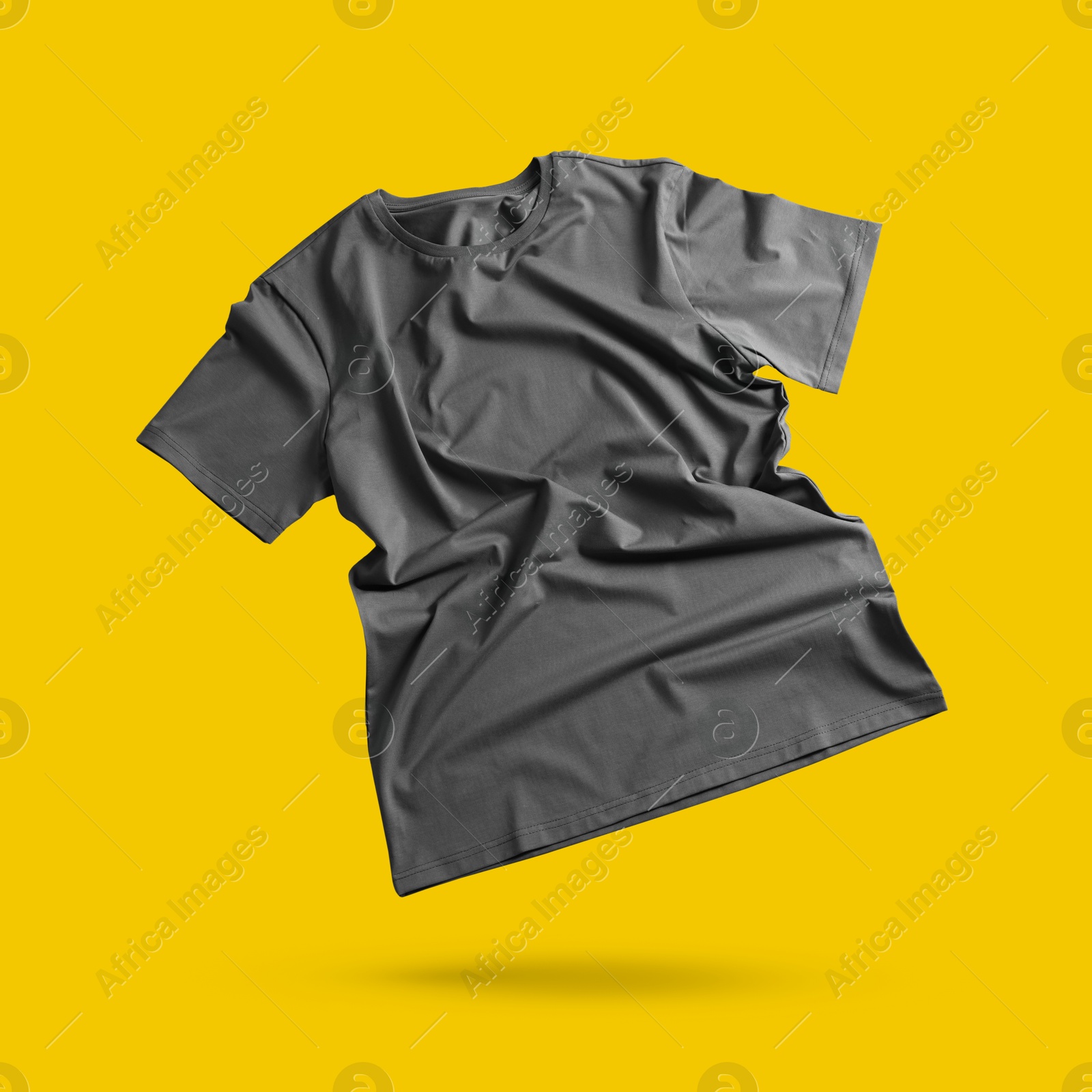 Image of Grey t-shirt in air on golden background