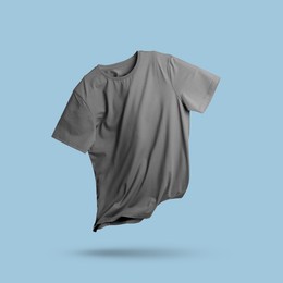 Image of Grey t-shirt in air on light blue background