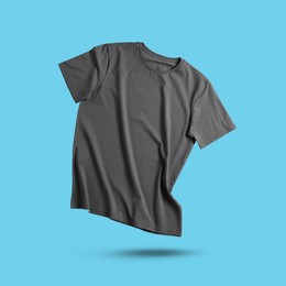 Image of Grey t-shirt in air on light blue background