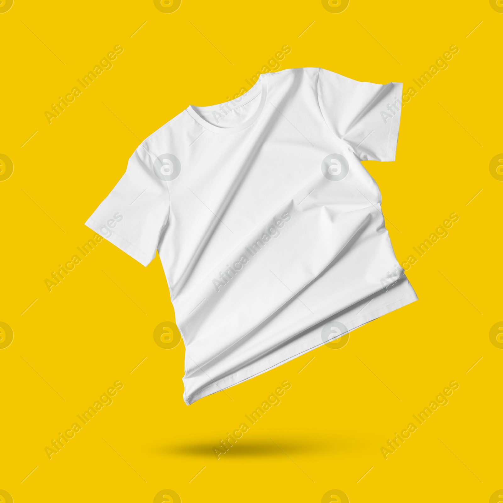 Image of White t-shirt in air on golden background