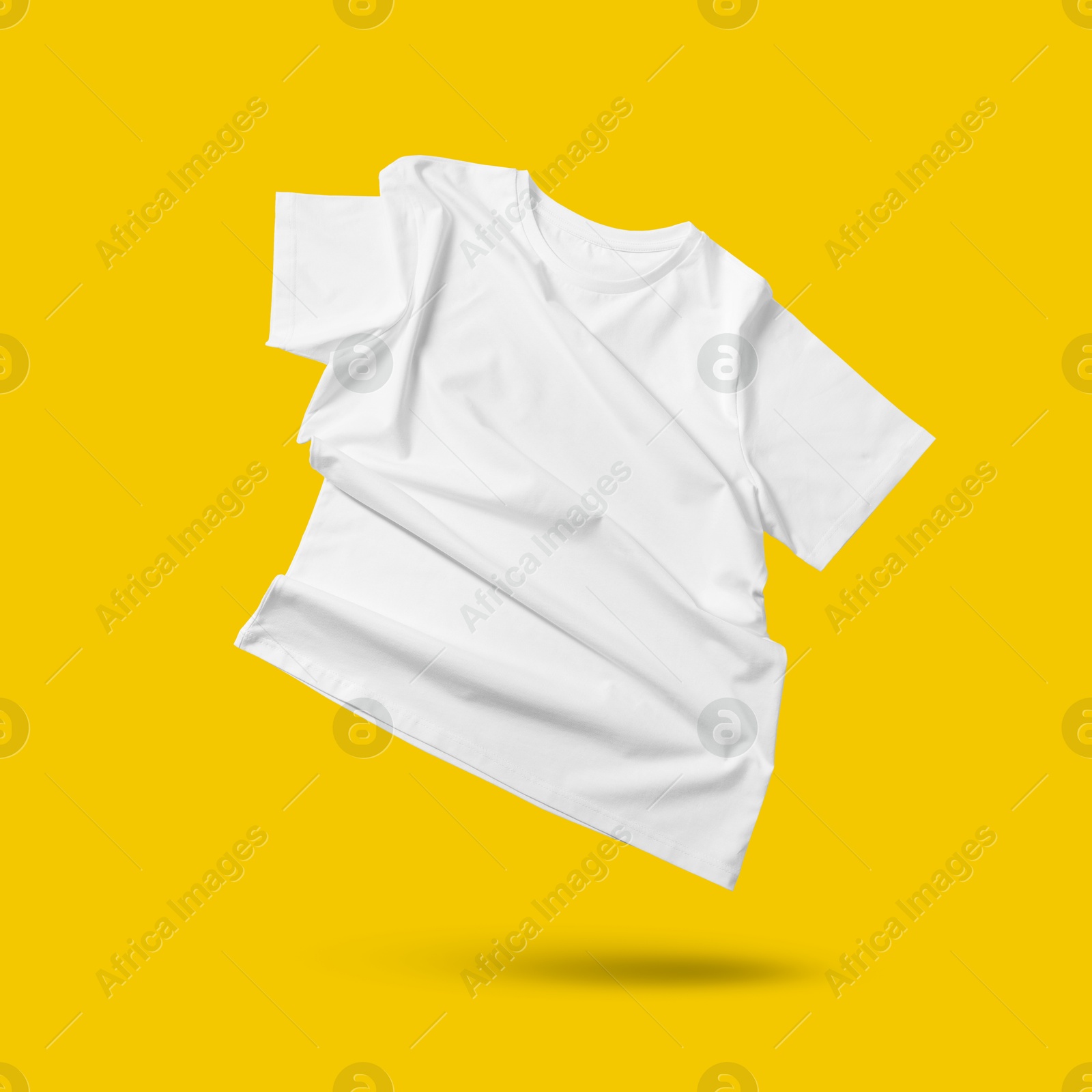 Image of White t-shirt in air on golden background