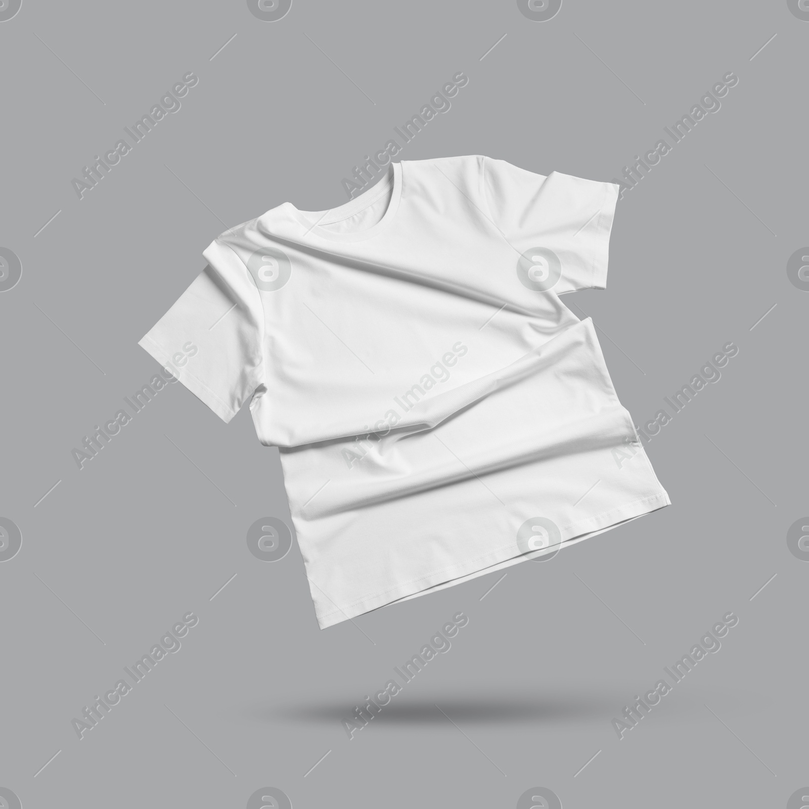 Image of White t-shirt in air on grey background