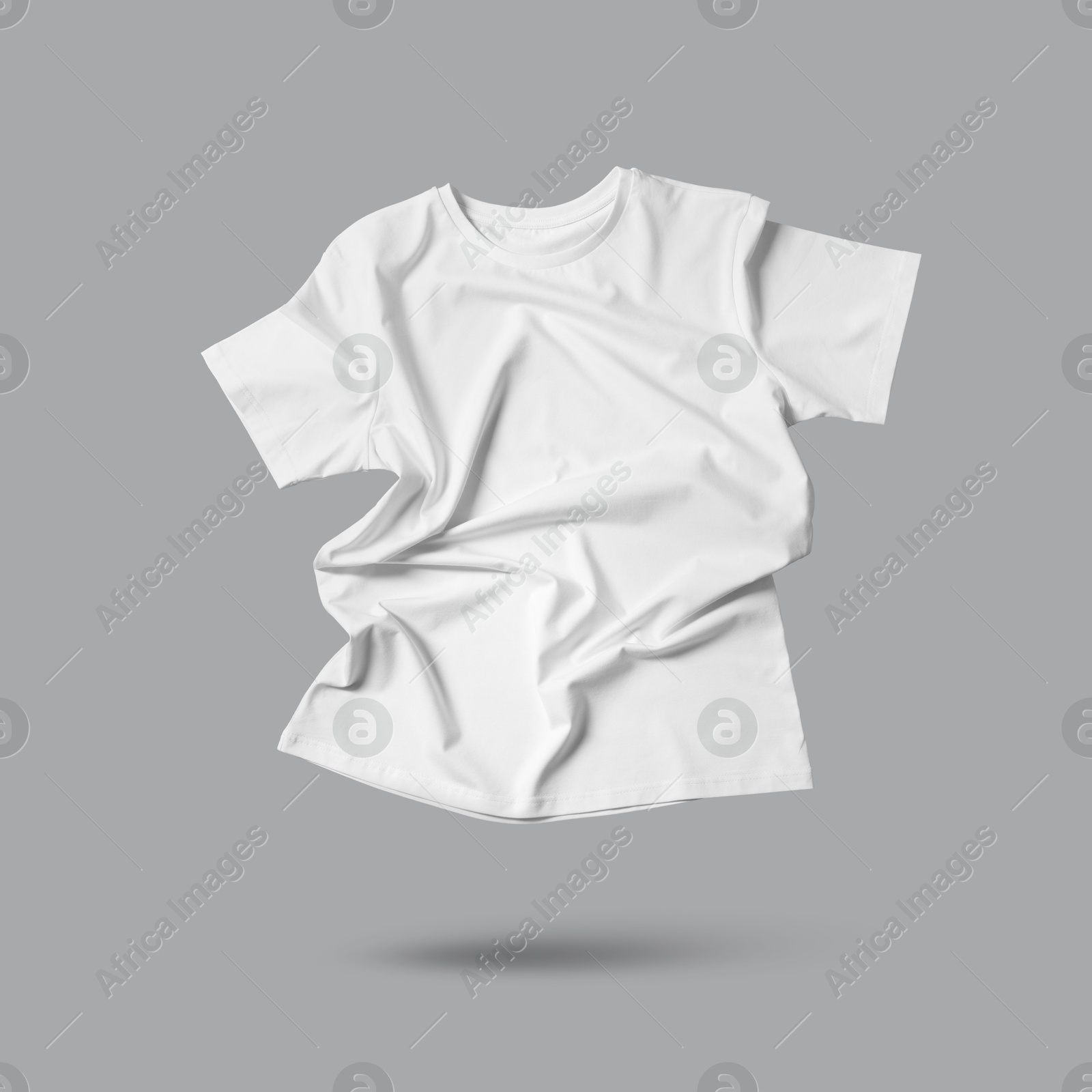 Image of White t-shirt in air on grey background