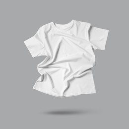 Image of White t-shirt in air on grey background