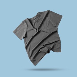 Image of Grey t-shirt in air on light blue background