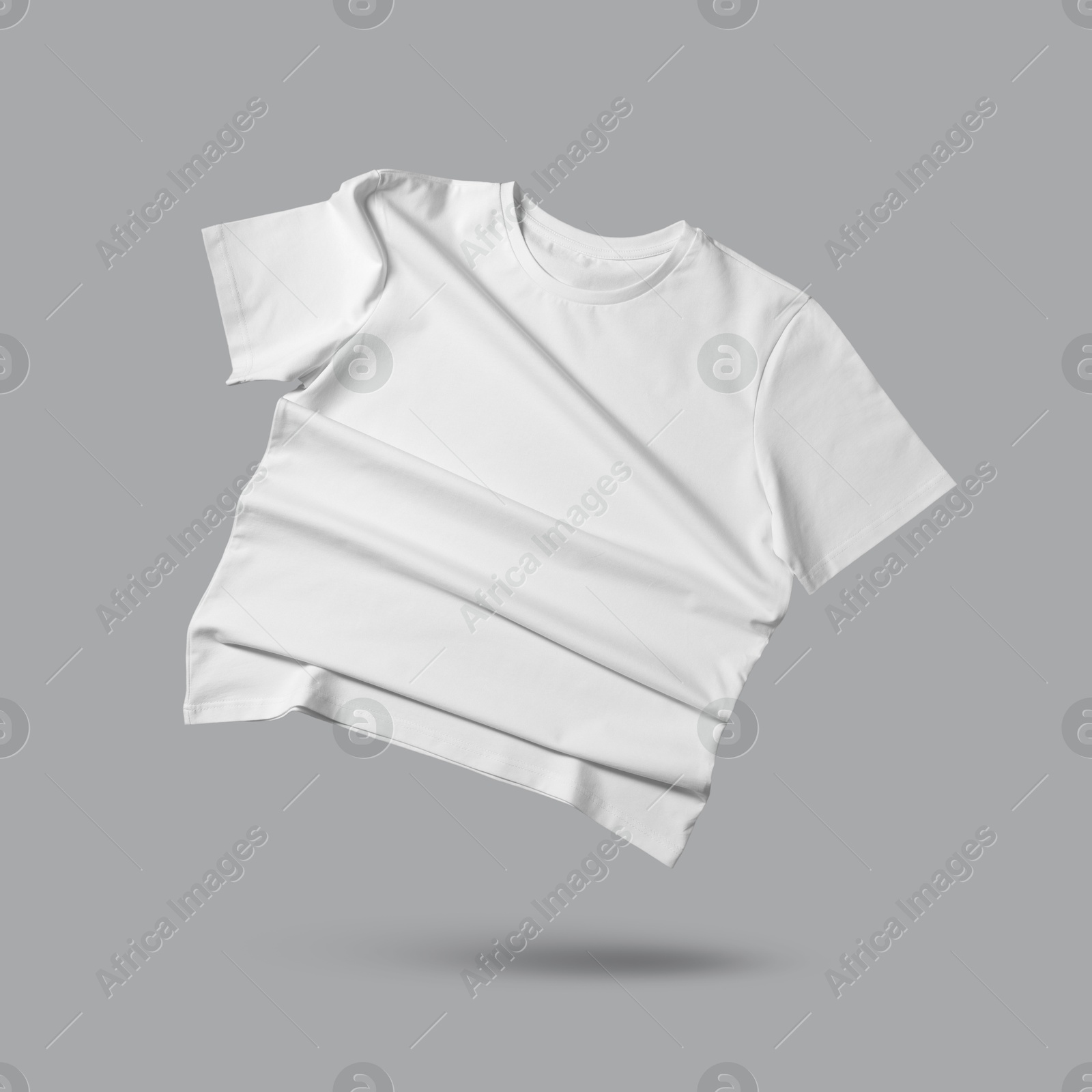 Image of White t-shirt in air on grey background