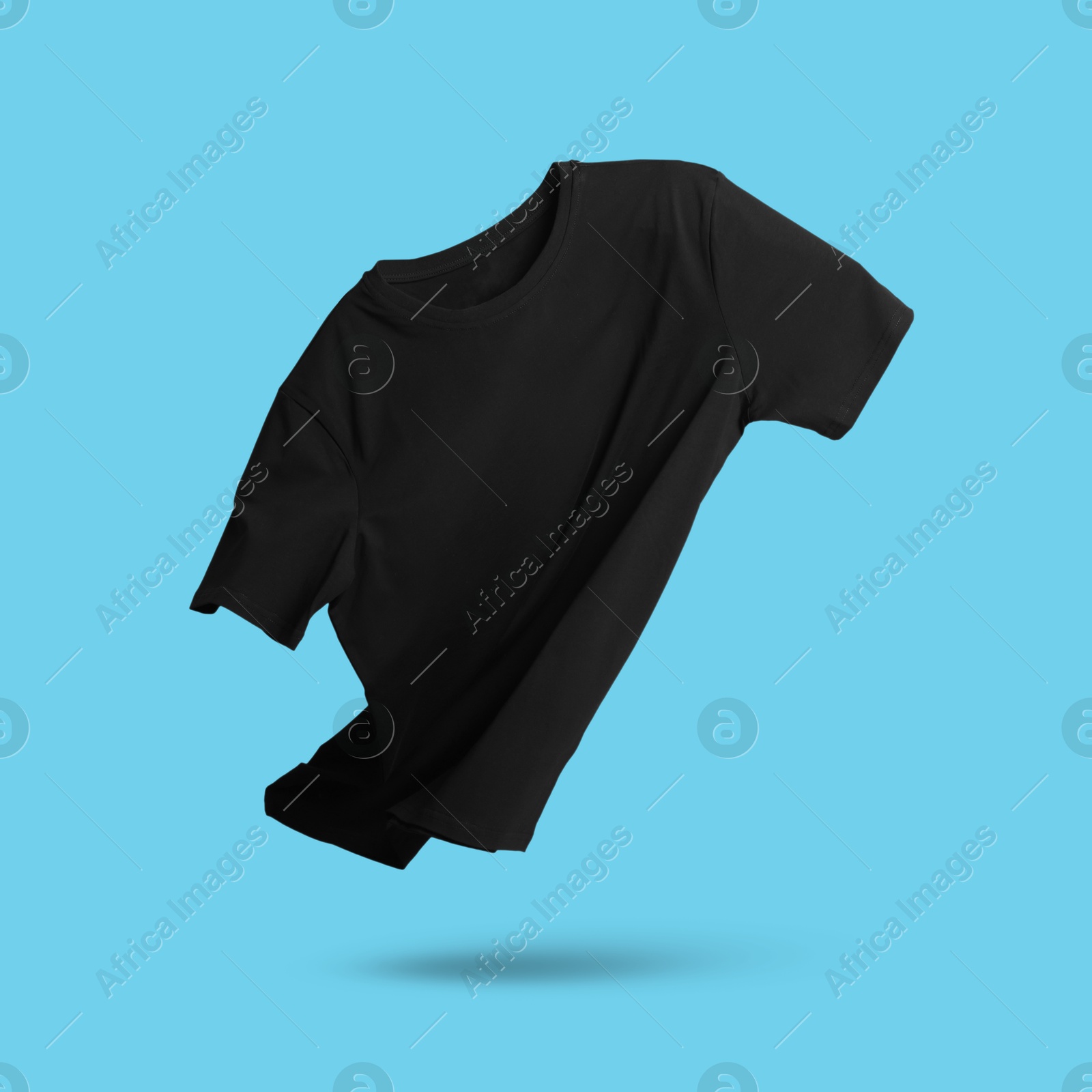 Image of Black t-shirt in air on light blue background