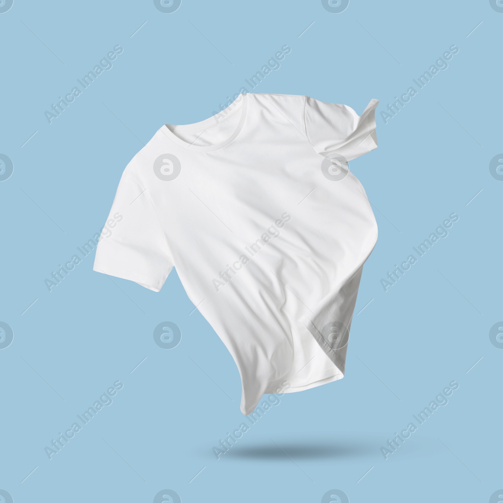 Image of White t-shirt in air on light blue background