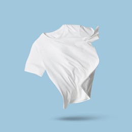 Image of White t-shirt in air on light blue background