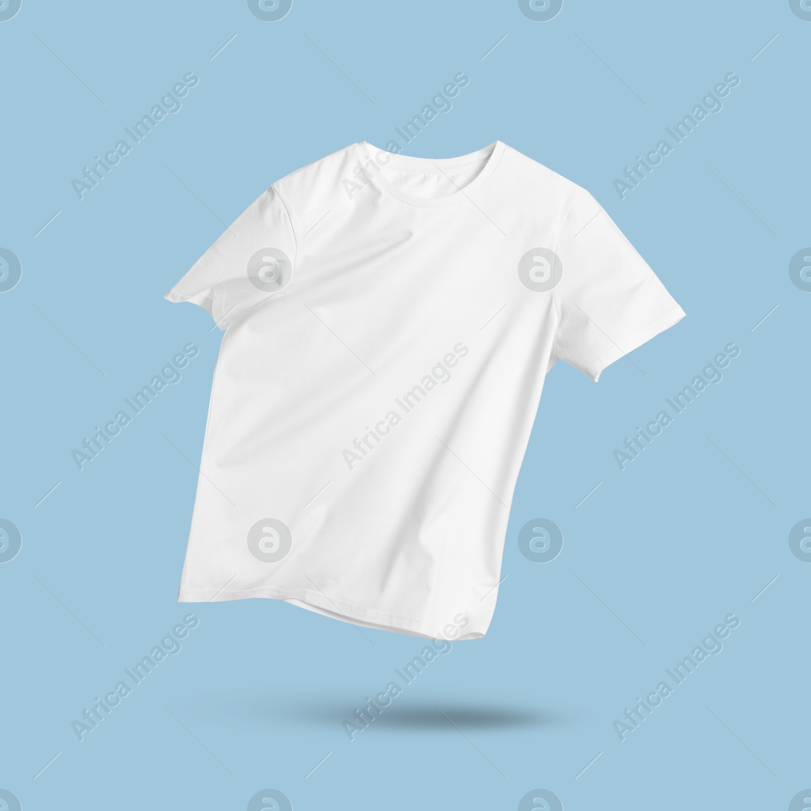 Image of White t-shirt in air on light blue background