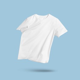 Image of White t-shirt in air on light blue background