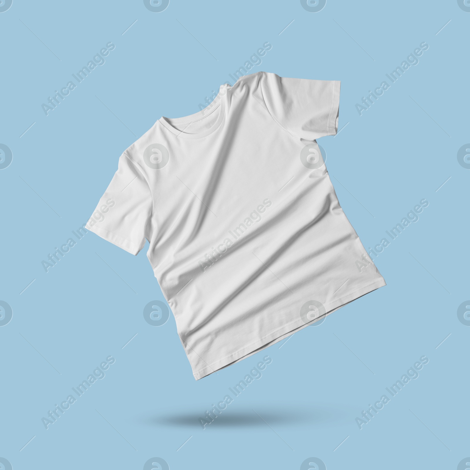 Image of White t-shirt in air on light blue background