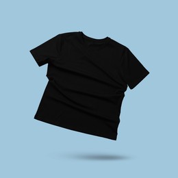 Image of Black t-shirt in air on light blue background