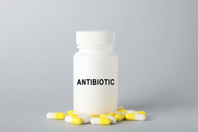 Image of Bottle of antibiotic pills on grey background