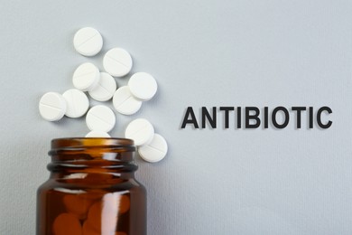 Image of Bottle of antibiotic pills on grey background, top view