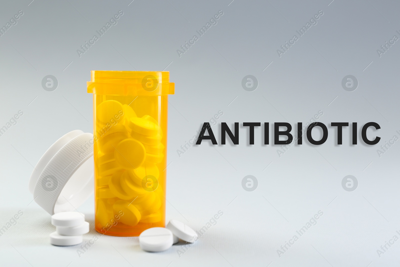 Image of Bottle of antibiotic pills on grey background