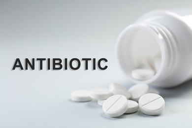 Image of Bottle of antibiotic pills on grey background, closeup