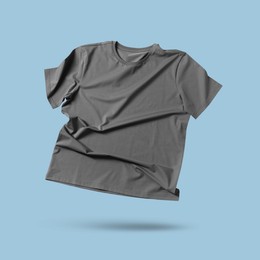 Image of Grey t-shirt in air on light blue background