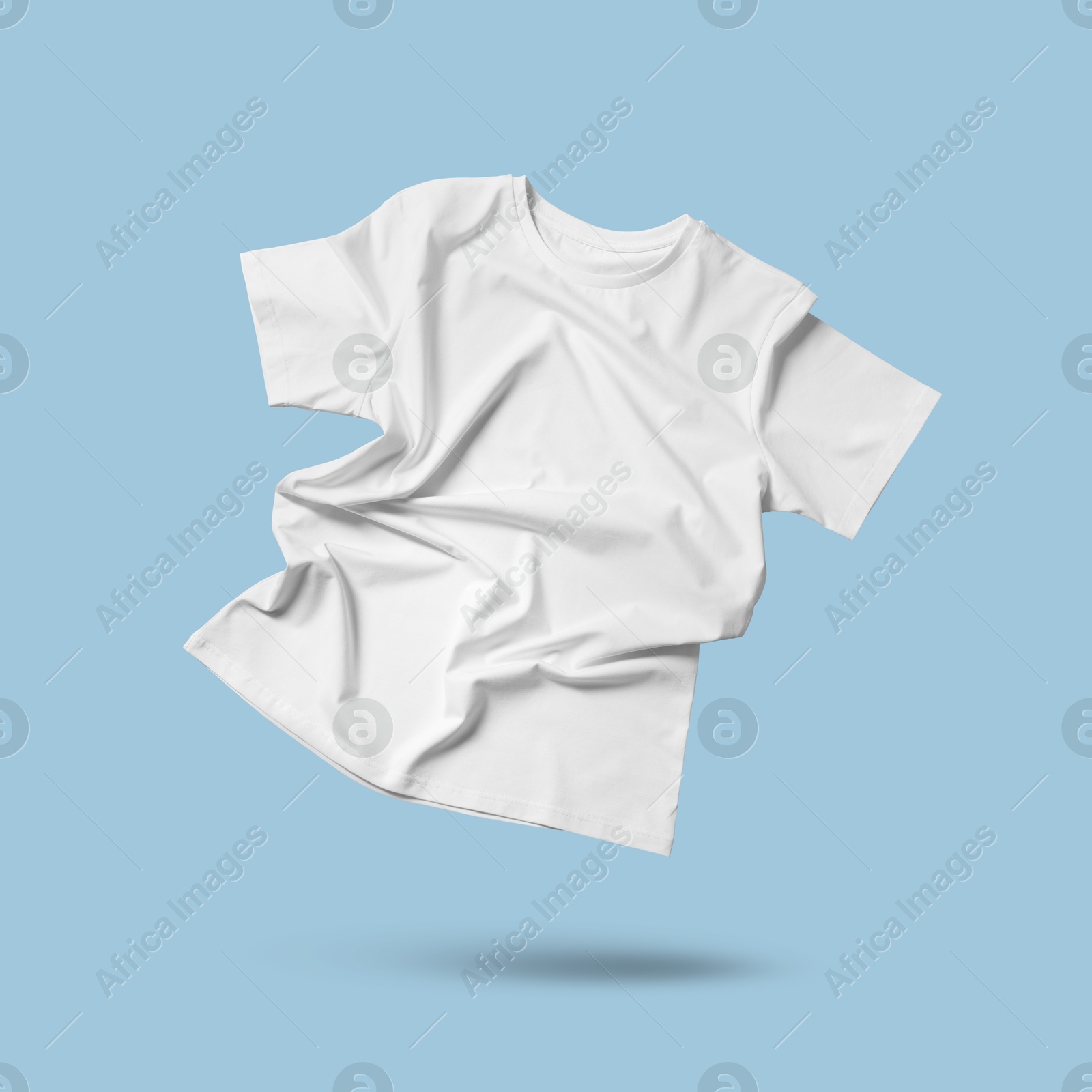 Image of White t-shirt in air on light blue background