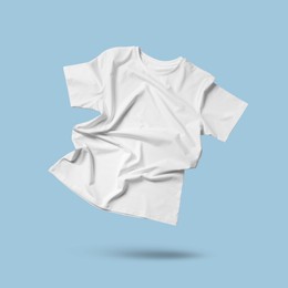 Image of White t-shirt in air on light blue background