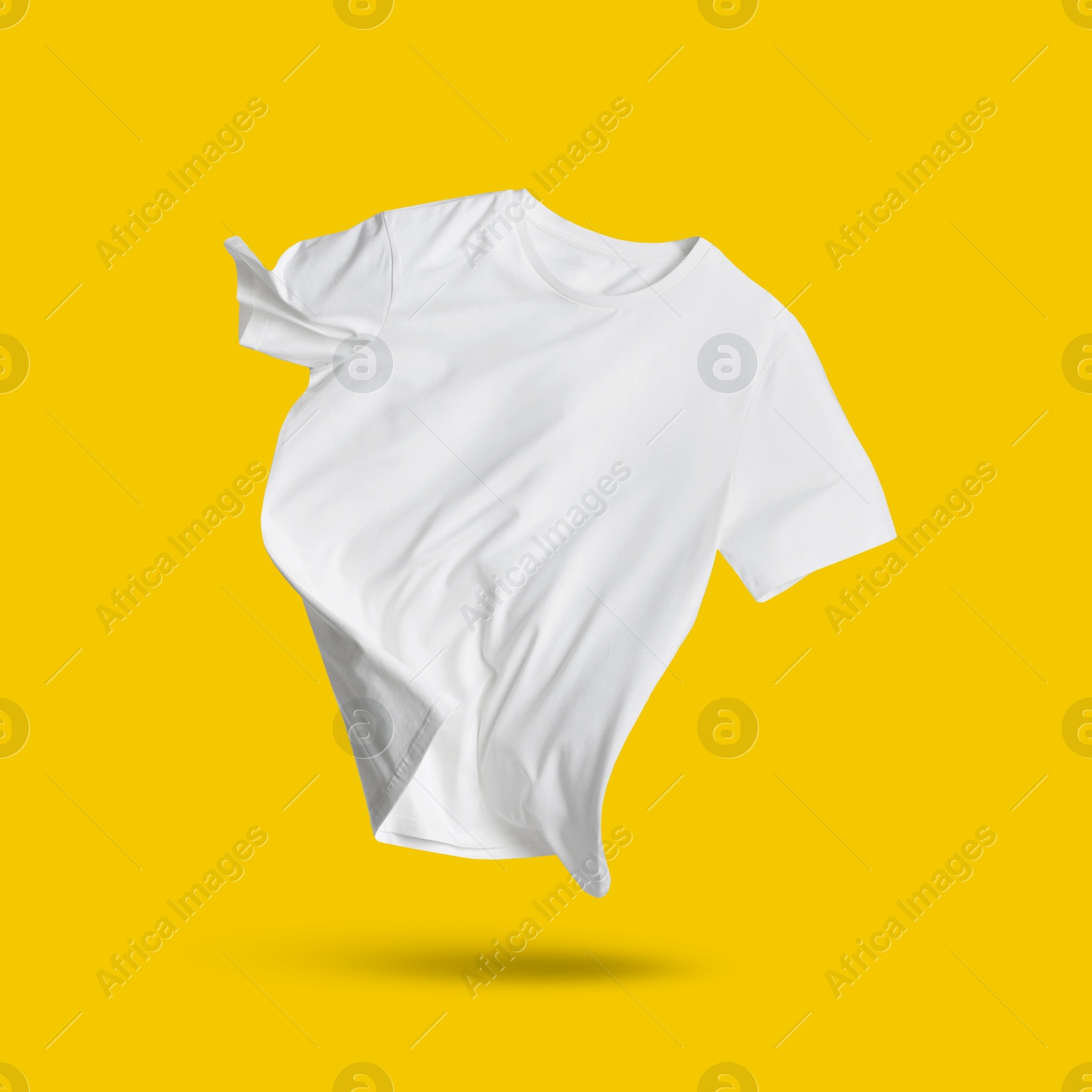 Image of White t-shirt in air on golden background