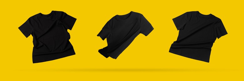 Image of Black t-shirts in air on golden background