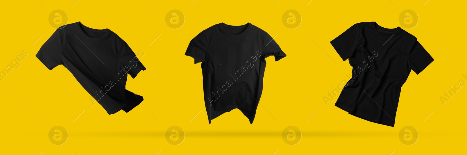 Image of Black t-shirts in air on golden background