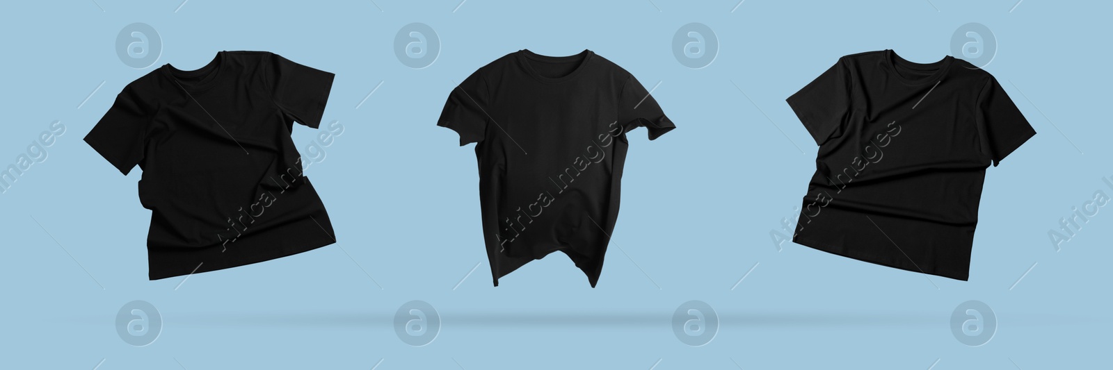 Image of Black t-shirts in air on light blue background