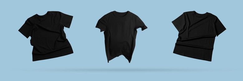 Image of Black t-shirts in air on light blue background