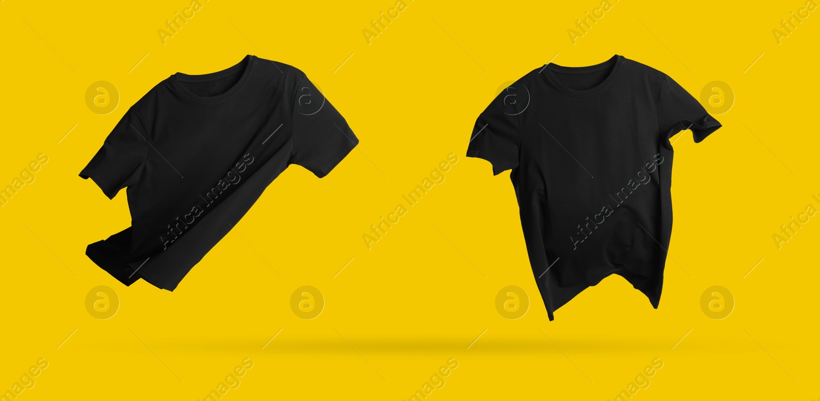 Image of Black t-shirts in air on golden background