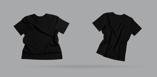 Image of Black t-shirts in air on grey background