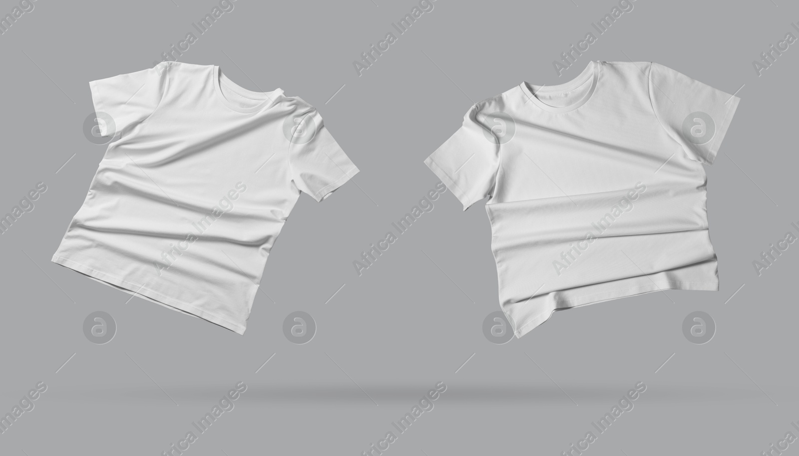 Image of White t-shirts in air on grey background