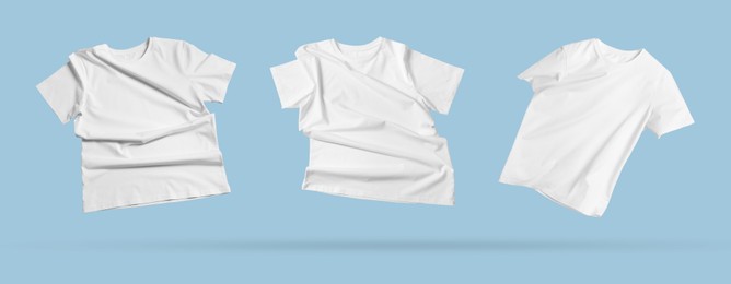 Image of White t-shirts in air on light blue background