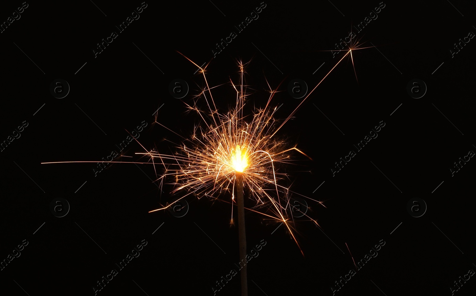 Photo of Burning sparkler on black background, space for text