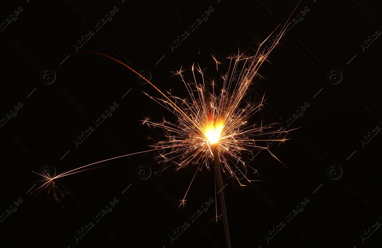 Photo of Burning sparkler on black background, space for text