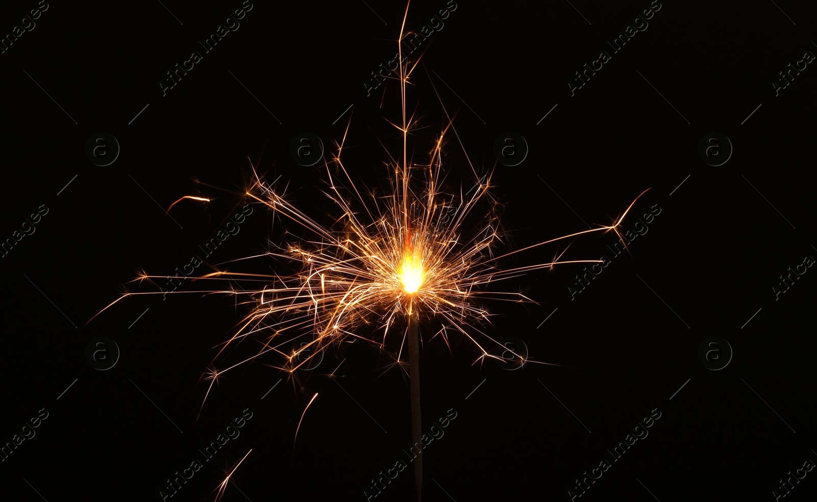 Photo of Burning sparkler stick on black background, space for text