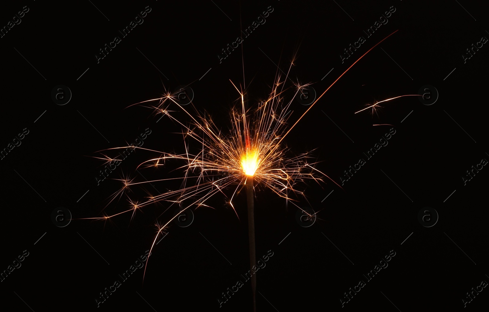 Photo of Burning sparkler stick on black background, space for text