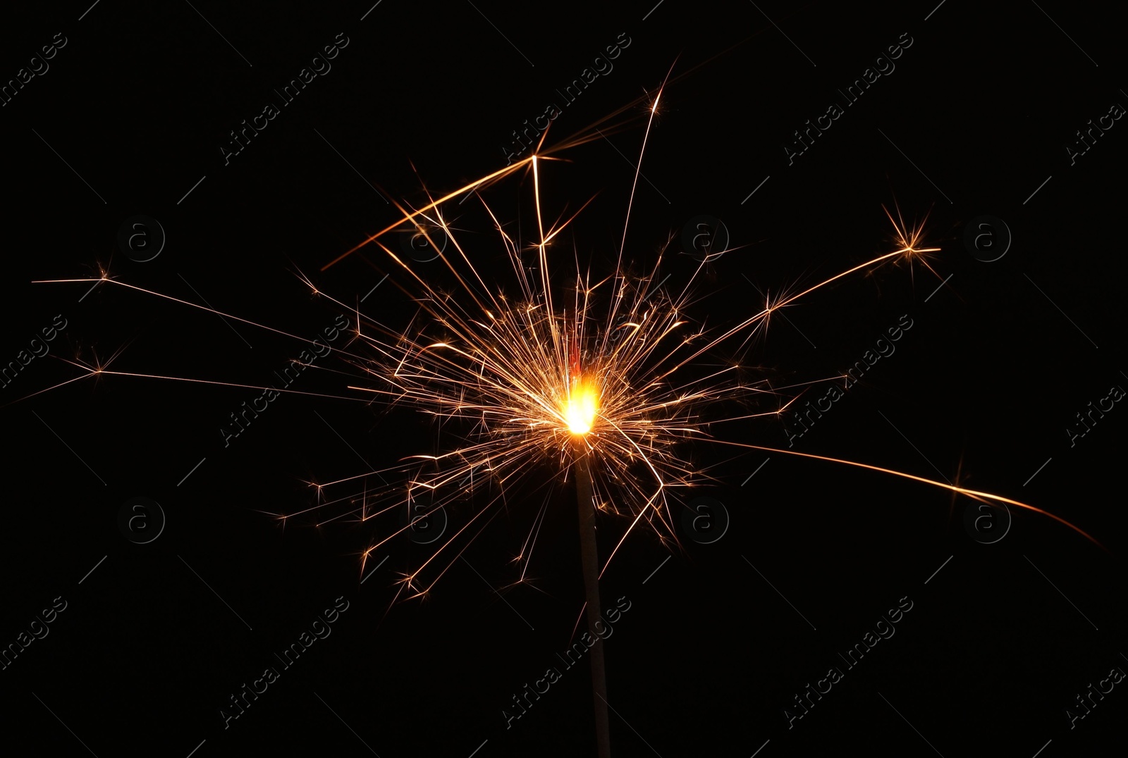 Photo of Burning sparkler stick on black background, space for text