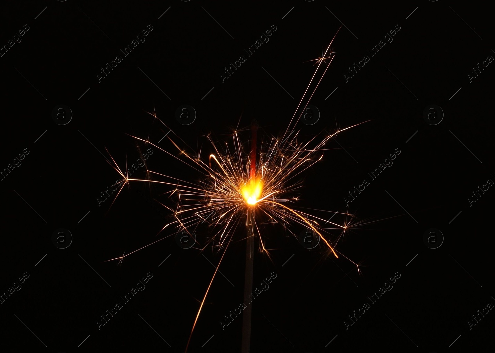 Photo of Burning sparkler stick on black background, space for text