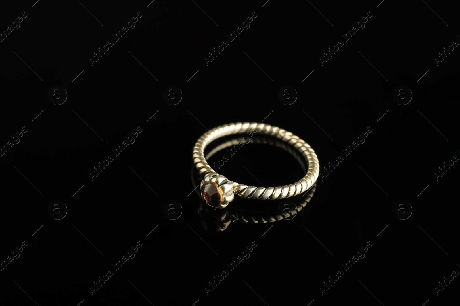 Photo of Beautiful bijouterie. Stylish ring on black background