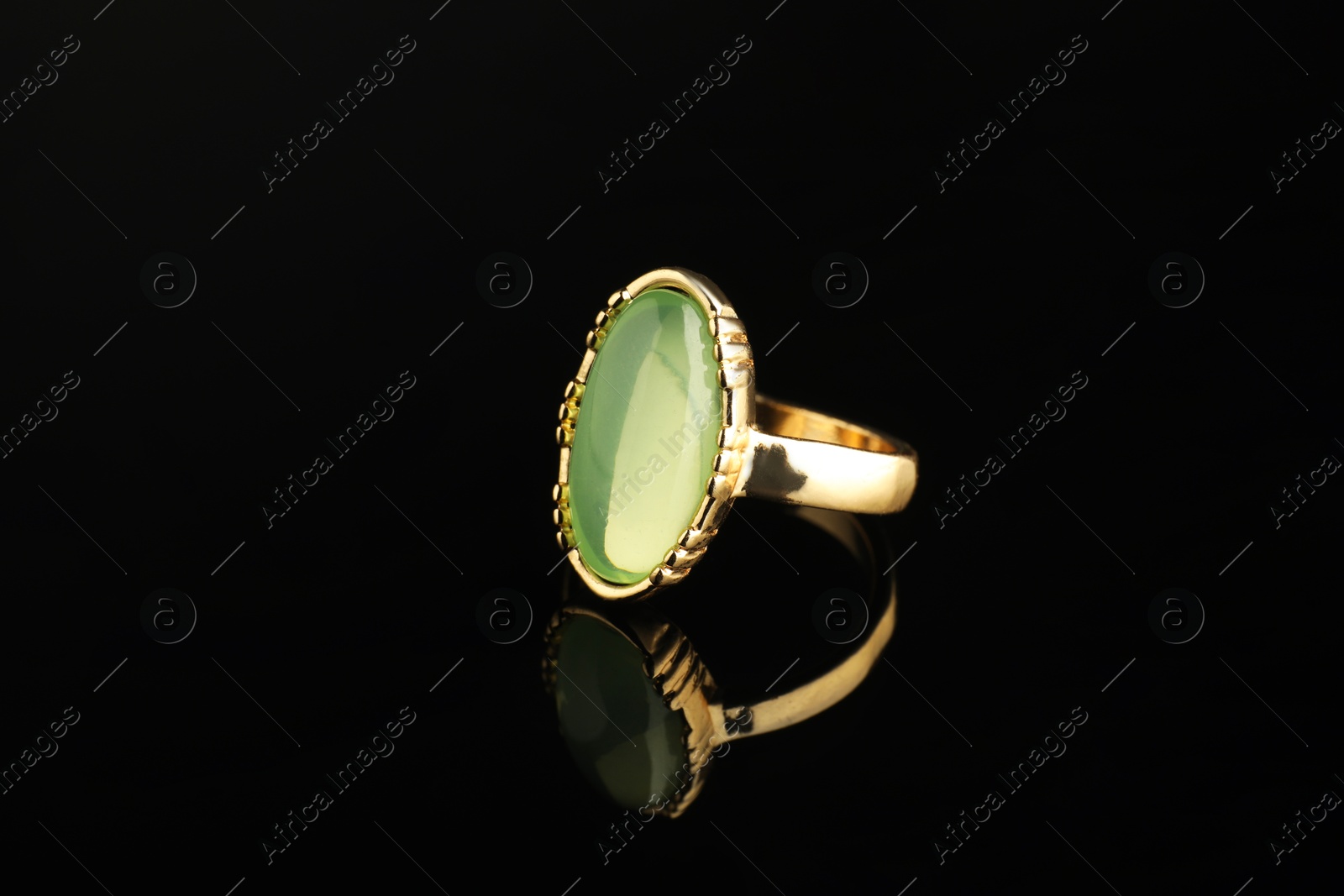 Photo of Beautiful bijouterie. Stylish ring on black background