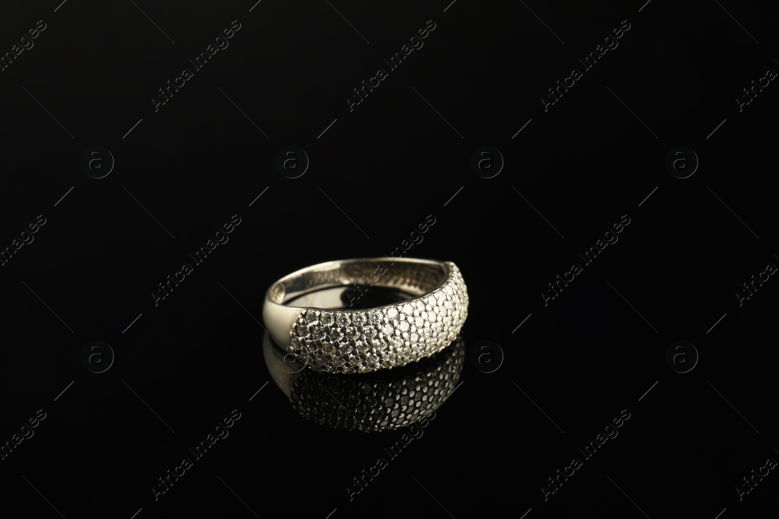 Photo of Beautiful bijouterie. Stylish ring on black background