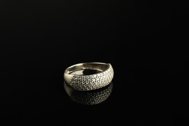 Beautiful bijouterie. Stylish ring on black background