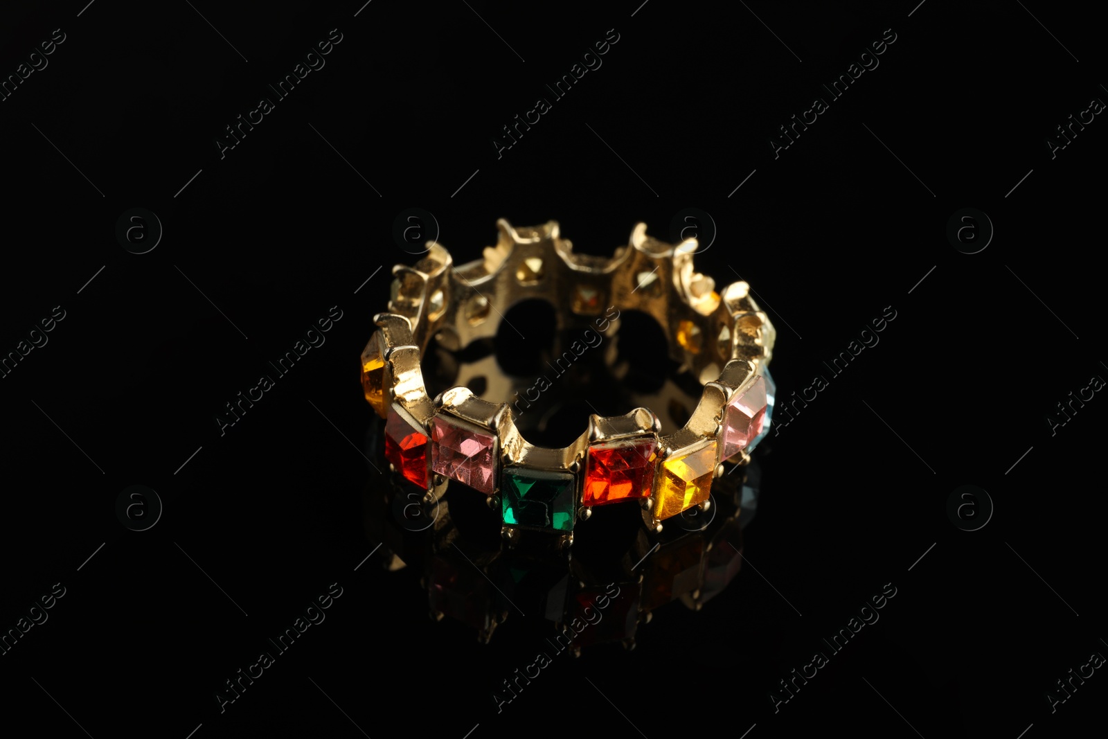 Photo of Beautiful bijouterie. Stylish ring on black background