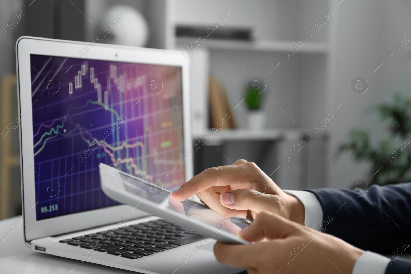 Photo of Businesswoman using tablet at white table indoors, closeup. Modern technology