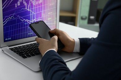 Photo of Businesswoman using smartphone at white table indoors, closeup. Modern technology